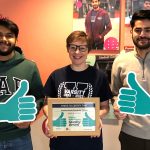 Students Union President and Students Union staff hold framed certificate