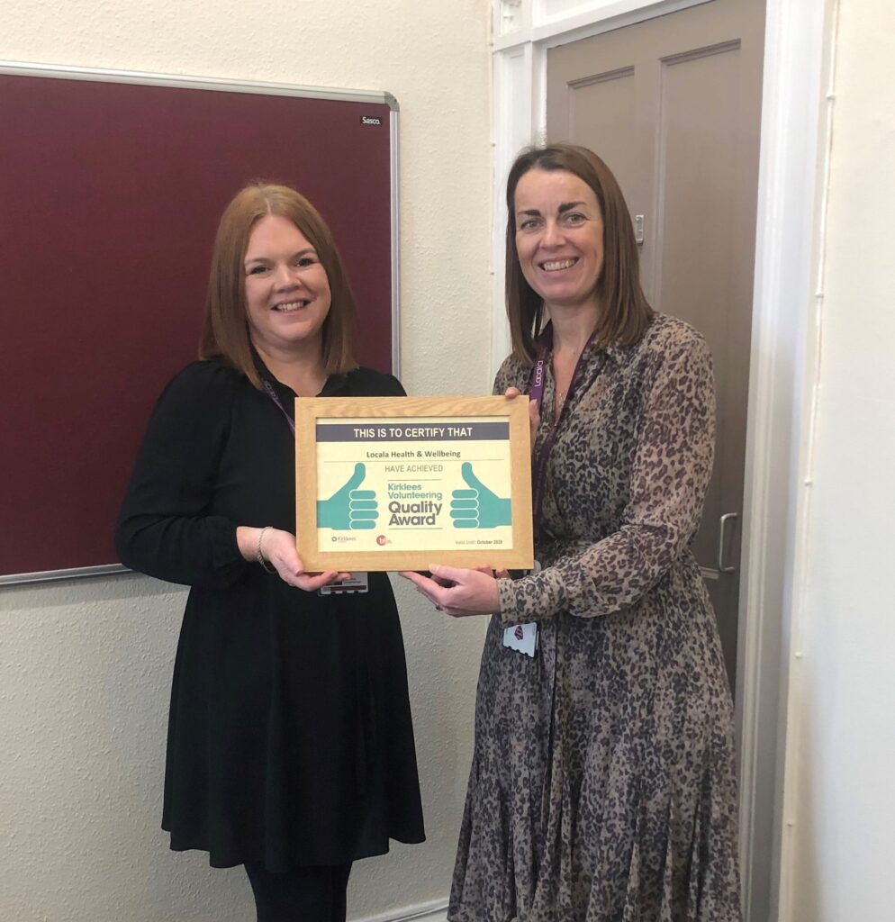 Heidi and Louise at Locala holding framed Quality Award certificate